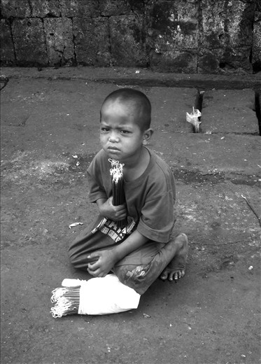 At four he roamed the streets with his older siblings selling candlles.