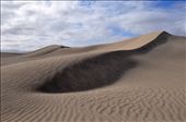 The beauty of these dunes belies their treacherous nature. Hills of sand stretch to the horizon, unspoilt by the presence of any living thing. The camera captures the symmetry and richness of the landscape, supporting a mirage of vitality amongst desolation.: by irc1111, Views[327]