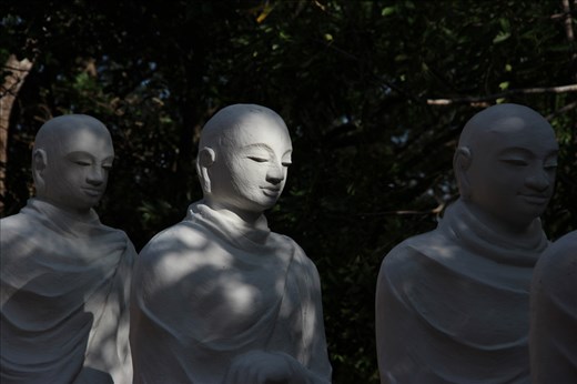 Some of the 500 monks' statues silently standing in line. Anuradhapura.
