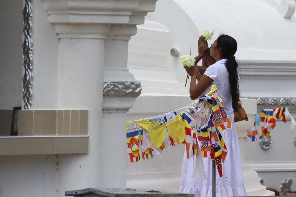 Women in devote prayer on one of the most ancient religious sites in Sri Lanka.