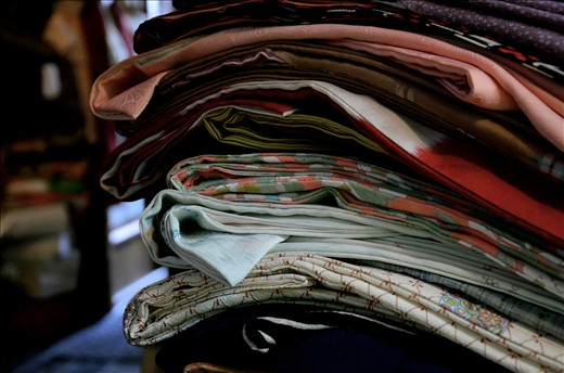 (2) As I sifted through the beautiful hand-painted and embroidered silks she told me about how, many years ago, she would sometimes buy, sell or repair kimono from the Okiya (the geisha houses in the Gion District of Kyoto), but hadn’t for many years. The numbers of geisha in Japan have fallen from 80,000 in the 1920s to as few as 1000 practicing today, and it is seen as a dying art.