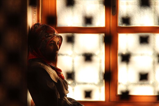 Behind a screen in the Sultan Ahmed Mosque, a woman has a private moment