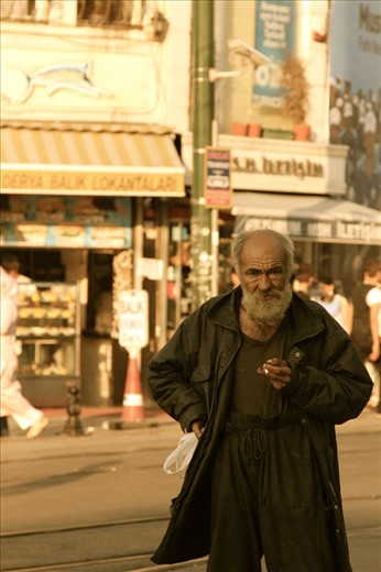 Street urchin amongst the rat race that plays out on the city's streets