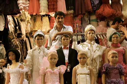 Spot the human: street vendor camouflages amongst his goods