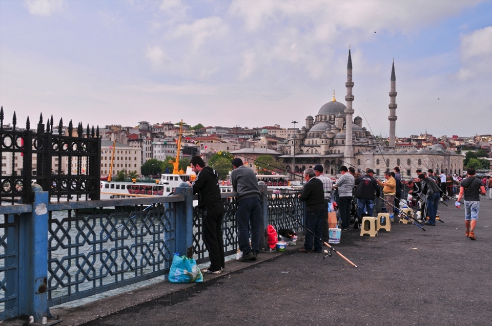 CATCHING LIFE ... an everyday event when the men line up along the bridge to catch fish to feed their families aswell as selling them to make money
