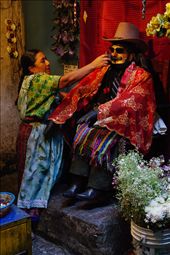 A wooden Maximon is offered a smoke from a wooden pipe as incentive to answer locals' prayers.: by itai, Views[357]