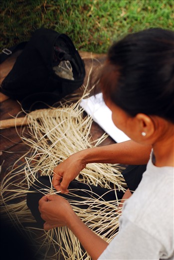 A young woman of the Hanunuo Mangyan tribe begins to weave buri, a type of palm into a basket. She is one of the last of her generation who continues to learn the endangered tradition of basket weaving. 