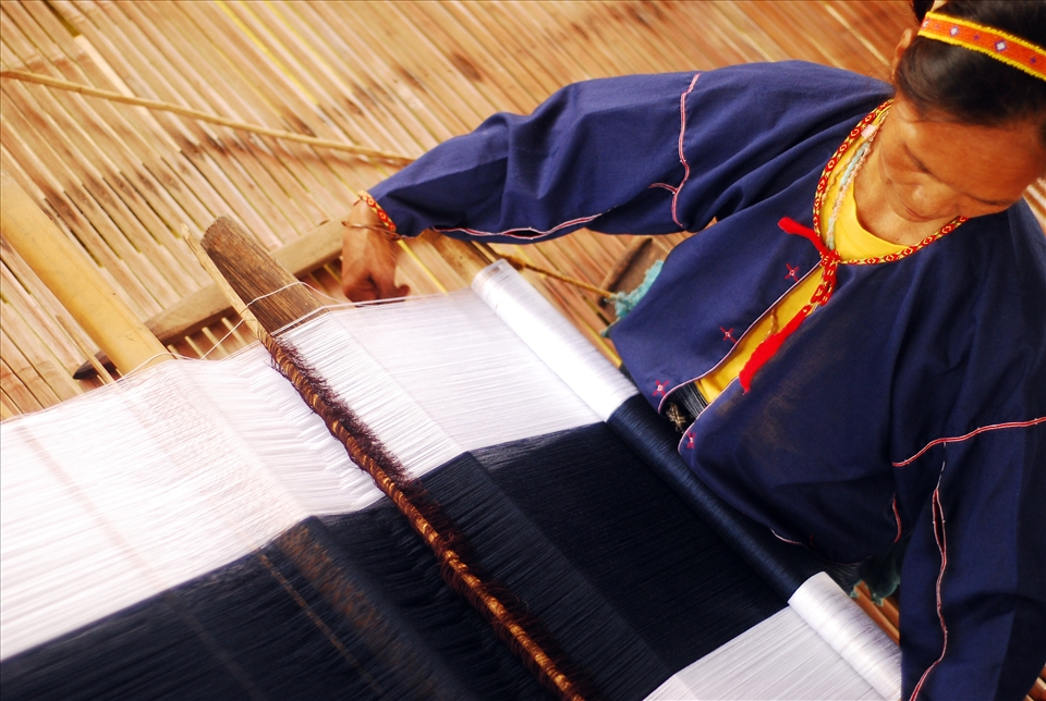 Baye Omeng weaves their traditional indigo and white fabrics on her backstop loom. They are one of the last tribes in the Philippines known to produce their own thread for weaving from the cotton plant. 