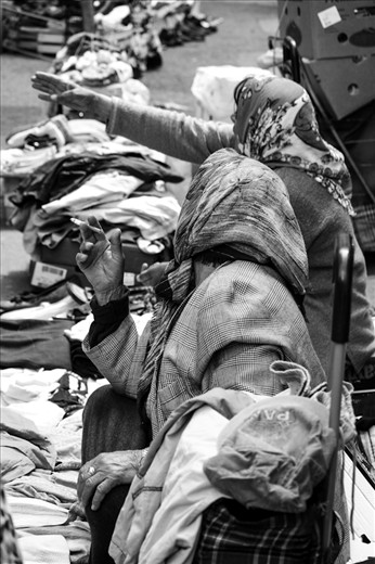 A woman showing the other woman were is a better place to sell goods