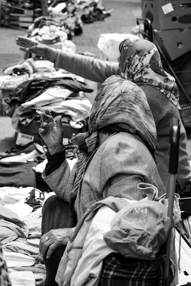 A woman showing the other woman were is a better place to sell goods