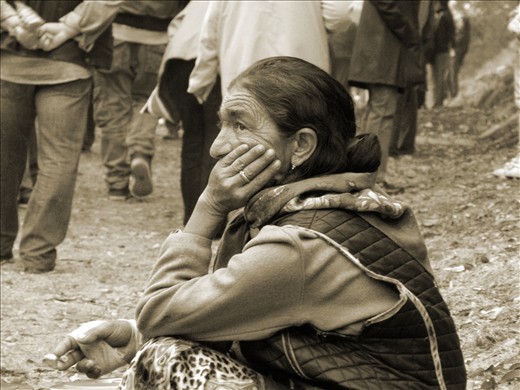 An old Gipsy woman begging in the crowd unsuccessfully