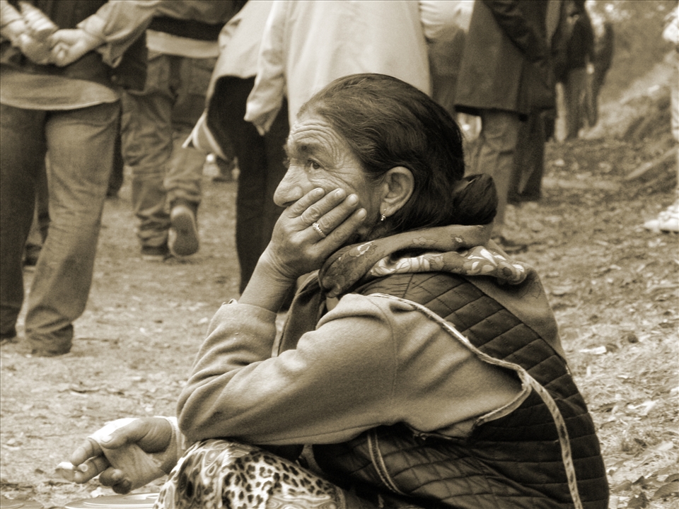 An old Gipsy woman begging in the crowd unsuccessfully