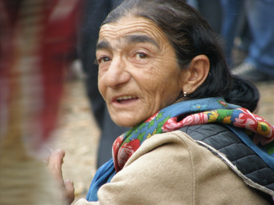 An old Gipsy woman begging in the crowd at a local food festival
