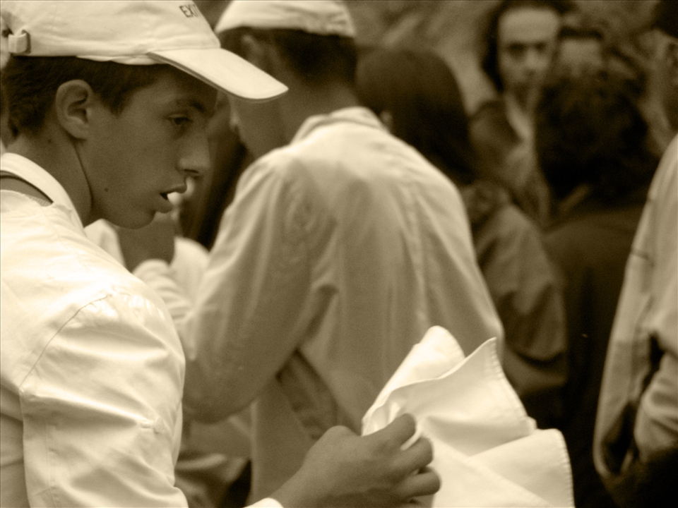 Local food festival - a young butcher in the crowd counting hours to the end