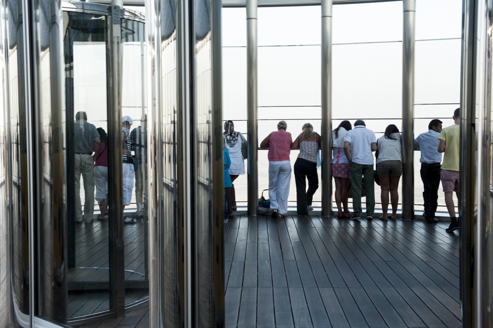 People look down at Dubai from viewing platform of Burj Khalifa