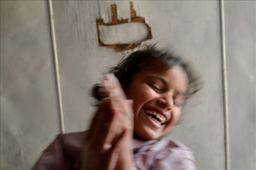 This is Bina. She was one of the more solemn & shy girls in the orphanage. This is the only photo I ever got of Bina smiling, and it was during ‘play time’. I was lying on my back with my feet in the air, and she was attempting to balance on my feet with her belly. 