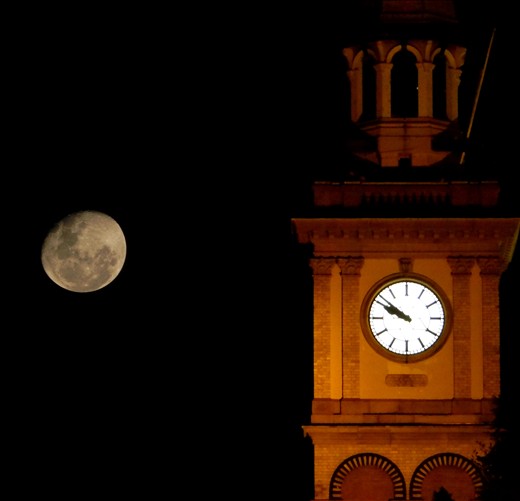The Customs house clock in Newcastle, as the moon rises behind it