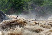 The sheer power of the river is clear as a fisherman struggles to reach the bamboo bridge. The fisherman use a combination of throw nets and bamboo fishing traps to catch migratory fish travelling up through the falls. Due to the nature of the traps’ location, the fishermen have to risk their lives navigating the falls across a series of bamboo bridges and rope lines, one small slip on the bamboo could result in death for the fisherman.: by jacobjamesphoto, Views[792]