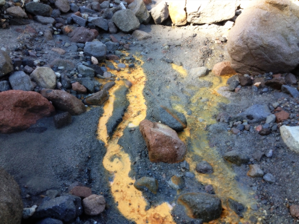 Sulfur still flows down the mountain, and the stench of it seeps through with your every breath.