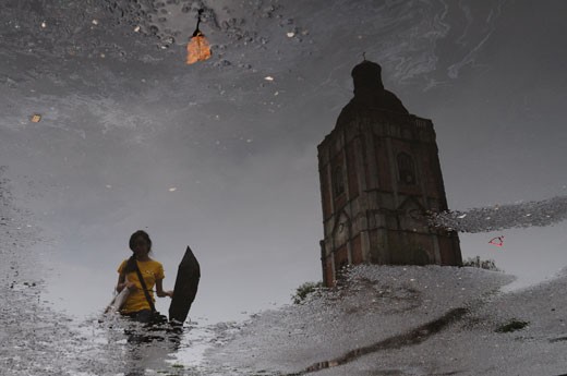 3.	The Belfry and the Girl with a Yellow Shirt. The old belfry of the Cathedral of the Roman Catholic Church in Jaro in Iloilo City is one of the most famous landmarks in Iloilo. Though several earthquakes have damaged the belfry it was repaired by devotees of the church, proving that trough a united faith as Christians, problems can be resolved. This picture was taken after a heavy afternoon rain.