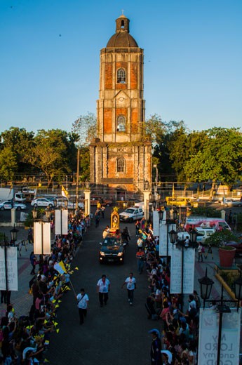 4.	Two Icons (Jaro Belfry and San Pedro Calungsod). The old belfry of the Cathedral of the Roman Catholic Church in Jaro in Iloilo City is an iconic symbol of Catholicism in Iloilo. It stood high enough to be seen by everyone who passes in the area. In this picture, it serves as background for the arrival to Iloilo of the image of San Pedro Calungsod, the second Filipino saint. The picture also shows the faithful uniting to welcome the saint. The setting sun highlighted both icons.
