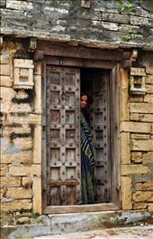 A curious yet cautious woman peers through her doorway.: by jailakhani, Views[266]
