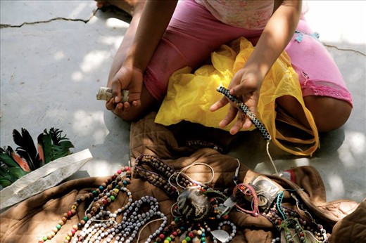 A child selling home made trinkets in the village of Magdalena, Peru.