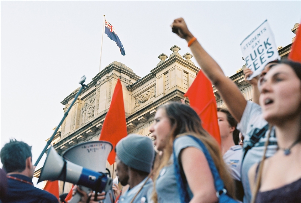 An Australian flag fly's high above the protestors
