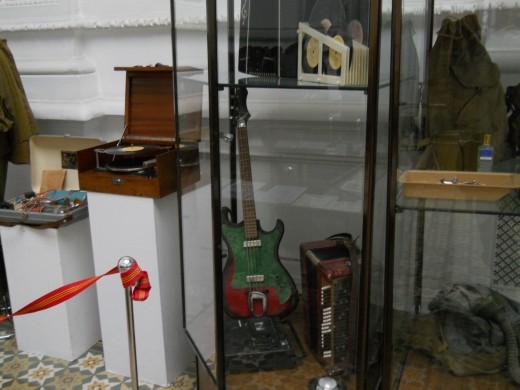 Someone's record player and bass guitar that were removed from the sight of the Chernobyl Nuclear disaster shortly after the meltdown.