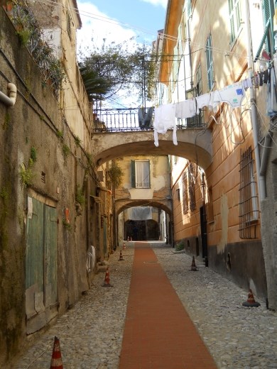 Walking through the narrow lanes of the Old Town in Ventimiglia, Italy. Like many of the hill towns, residents still live in the centuries old homes.