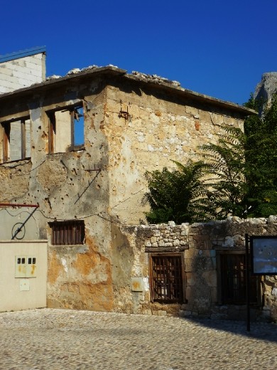 Bullet holes and shrapnel scarred building Mostar