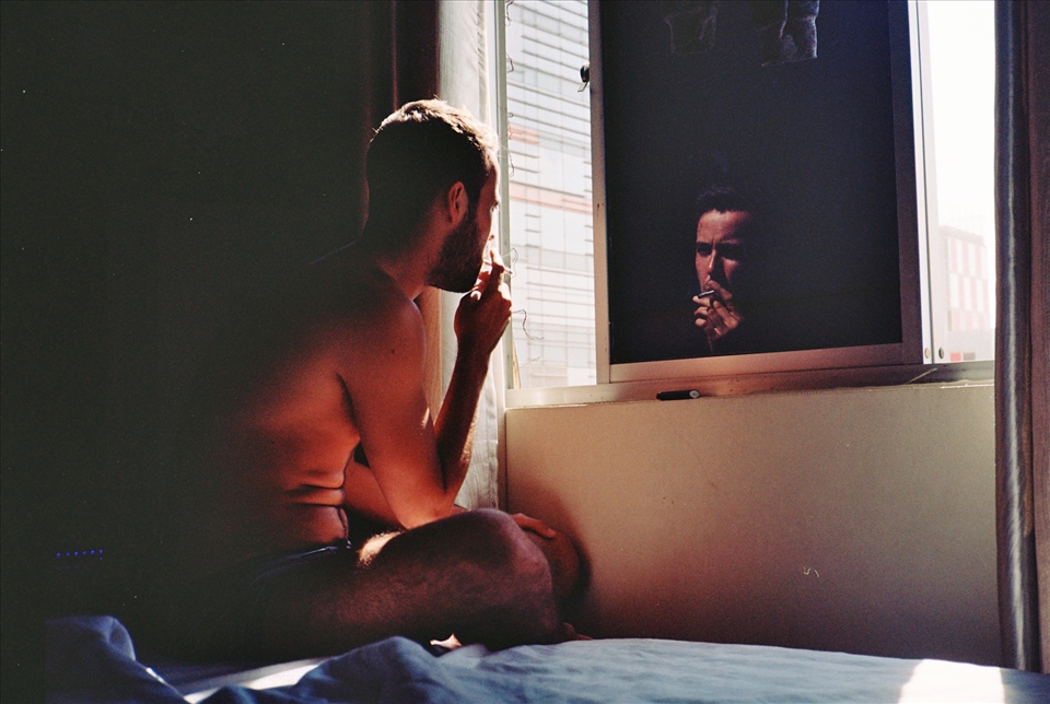 Adam smoking in a hotel room in Ho Chi Minh City