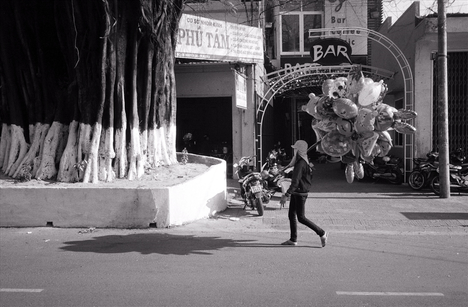 A lady carries balloons on a hot morning in Nah Trang