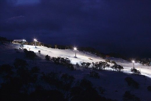 A lone 'Snow Cat' grooms the slopes after lifts have closed at Front Valley of Perisher Ski Resort, Kosciuszko National Park, AUSTRALIA. 2013 has seen a slow start to the snow season, relying heavily on man made snow and cloud seeding to boost snow depth for consumers.