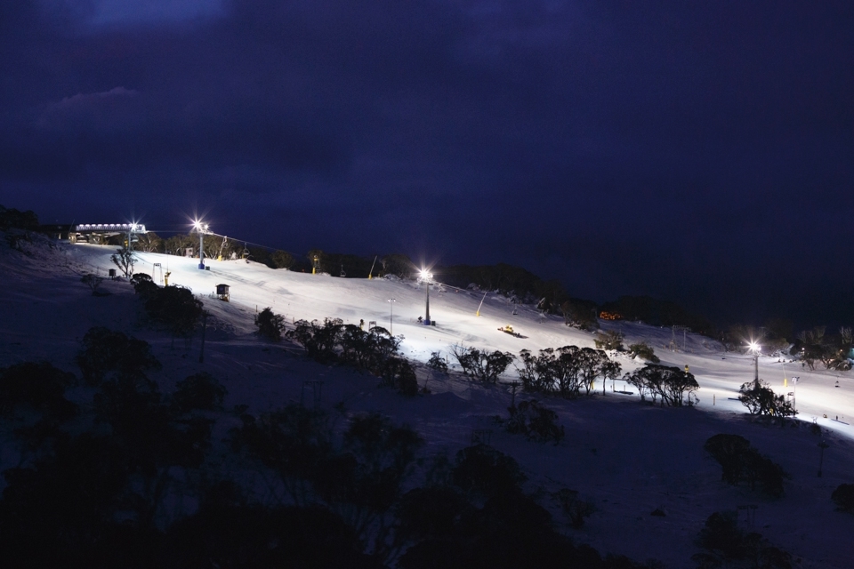 A lone 'Snow Cat' grooms the slopes after lifts have closed at Front Valley of Perisher Ski Resort, Kosciuszko National Park, AUSTRALIA. 2013 has seen a slow start to the snow season, relying heavily on man made snow and cloud seeding to boost snow depth for consumers.