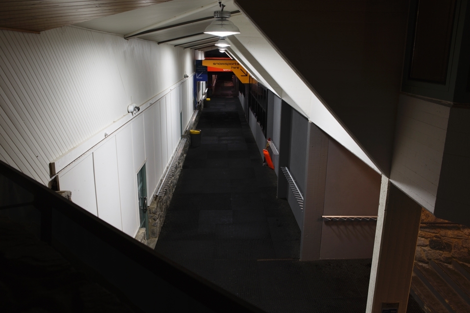 Architectural lines frame the main building of Perisher Resort's Front Valley after closing time. This section of walkway is the main throughfare from the car park to ski hire, lift ticket sales and the beginner ski lifts. During the day, hundreds of snowboards and skis will line the racks along either side of this corridor of high activity.