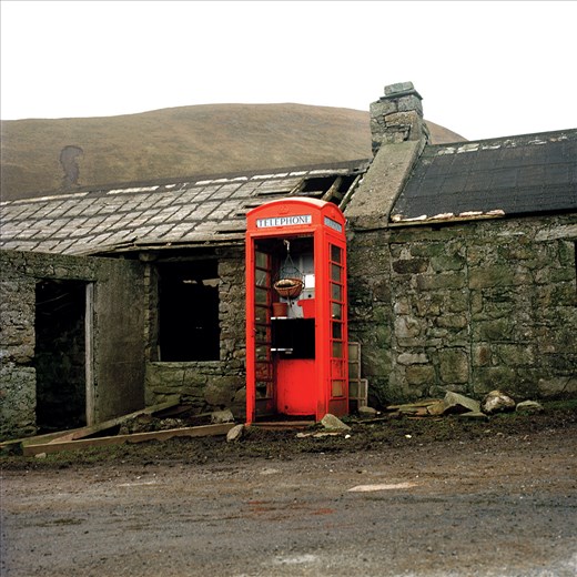 The old Post Office. A flowerpot hangs in the once, only point of communication.