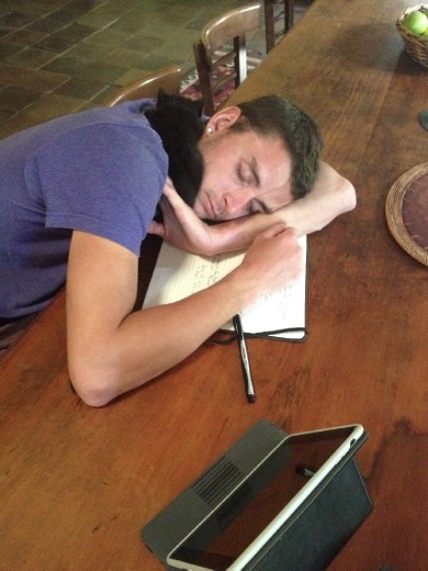 Cheyne and kitty fast asleep on the kitchen table in Berry