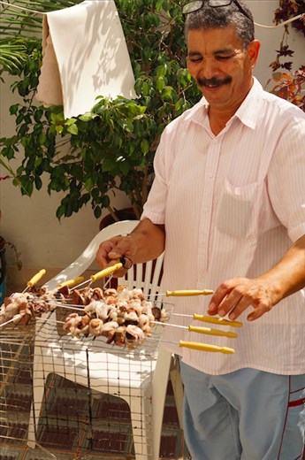 Back at the house, Muhammad helps prepare the sheep for eating. The heart, lungs, and liver are cooked and eaten first before anything else. Everyone helps with preparing the meal, whether it’s cutting the meat, cooking, or making the salad. 