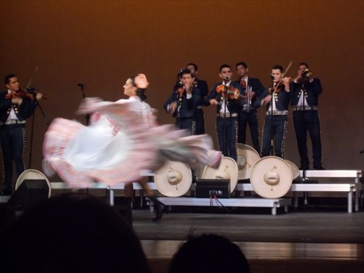 A folklorico dancer with the mariachi band