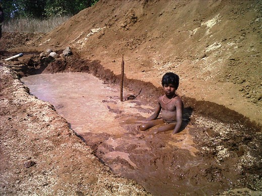 Lost Childhood- a child works 12 hours  uses his whole body to churn the mixture