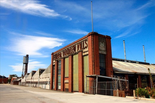 In architecture, drawing sometimes show people to give the building a sense of scale. However, I prefer the ambiguity where the viewer can decide on the scale of what they see.
In the rear carpark of an antique market in Geelong stands this old abandoned building amongst an industrial landscape looking slightly out of place with its brick colonnade hinting a grander past.