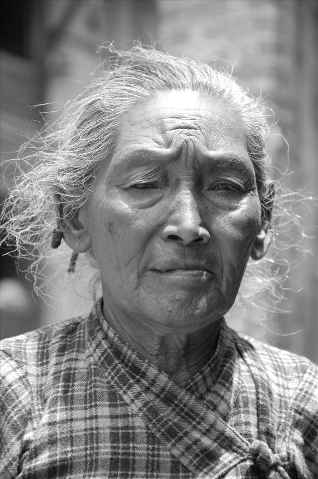 The lines on her face shows a hard life with the weight of the world in her eyes