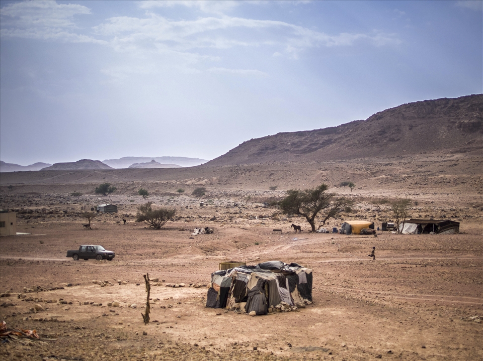 There is a striking contrast between the severe landscape and the relaxed people who inhabit it. It’s as if the land itself has coached the Bedouin to accept life on its own terms. Mahmoud (running to the right) lives in the house at the bottom of the photo. He spends much of his day walking up and down the road playing characters to the other families with the debris he finds either side of the road but the highlight for him is when he races his uncles ancient vehicle for the two hundred metres from his house to the next. Toughened bare feet hammering the sharp stone, his uncle laughing affectionately the whole way, amidst all the hardship of the daily jobs he is victorious on a daily basis. 