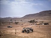 There is a striking contrast between the severe landscape and the relaxed people who inhabit it. It’s as if the land itself has coached the Bedouin to accept life on its own terms. Mahmoud (running to the right) lives in the house at the bottom of the photo. He spends much of his day walking up and down the road playing characters to the other families with the debris he finds either side of the road but the highlight for him is when he races his uncles ancient vehicle for the two hundred metres from his house to the next. Toughened bare feet hammering the sharp stone, his uncle laughing affectionately the whole way, amidst all the hardship of the daily jobs he is victorious on a daily basis. : by jasondury, Views[273]