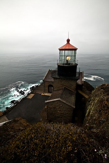 The Point Sur lighthouse operates in the gloom of the Pacific