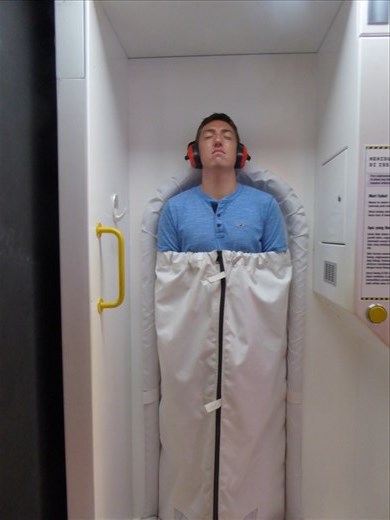 Jason sleeping like a spaceman in the Science Centre