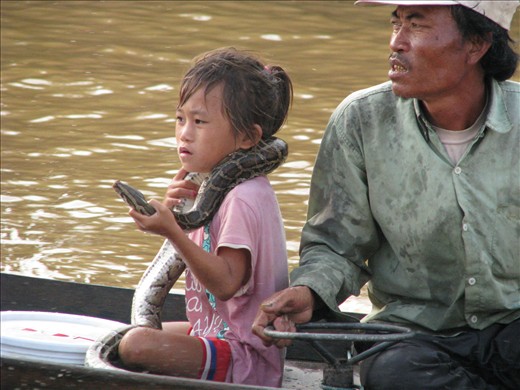 Vietnamese refugees on Cambodian river selling tourists photo opportunities  