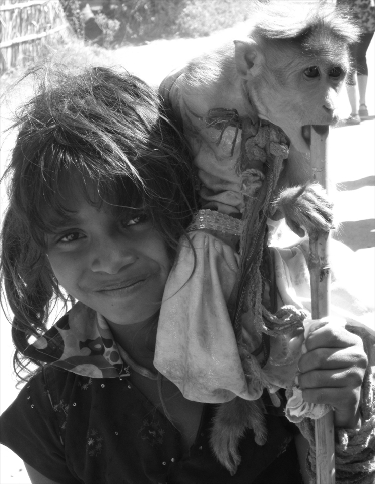 Serious(girl) complementing the carefree(monkey). Hampi, India.