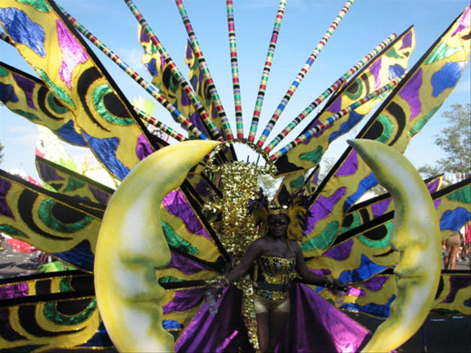 An extravagant Caribbean Goddess during the Scotiabank Toronto Caribbean Carnival, a special event that is still most widely recognized as Caribana, despite the recent name change. The street festival and huge parade celebrates culture and tradition with numerous floats, music and dancing.